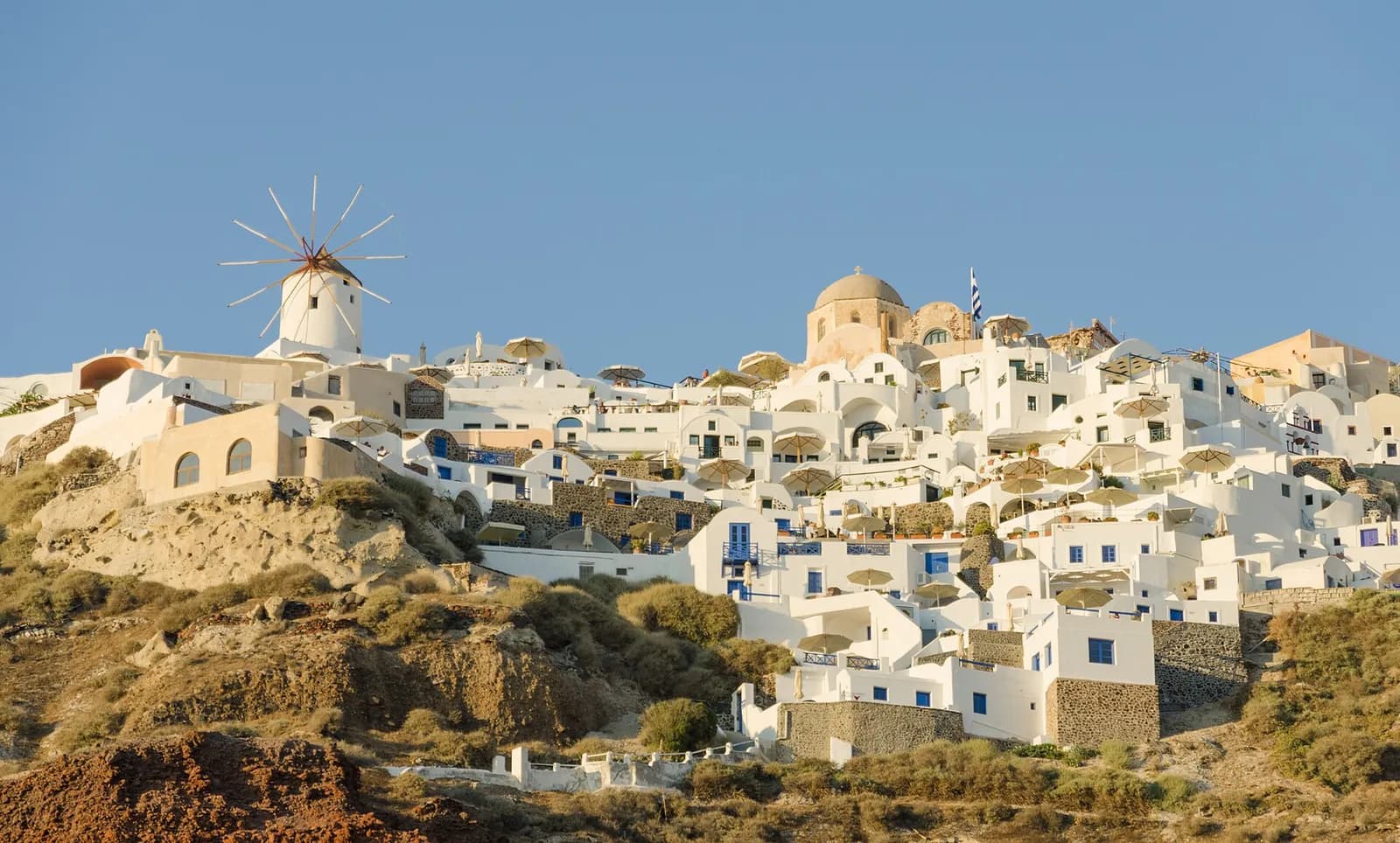 the village of Oia and its windmills seen from the caldera