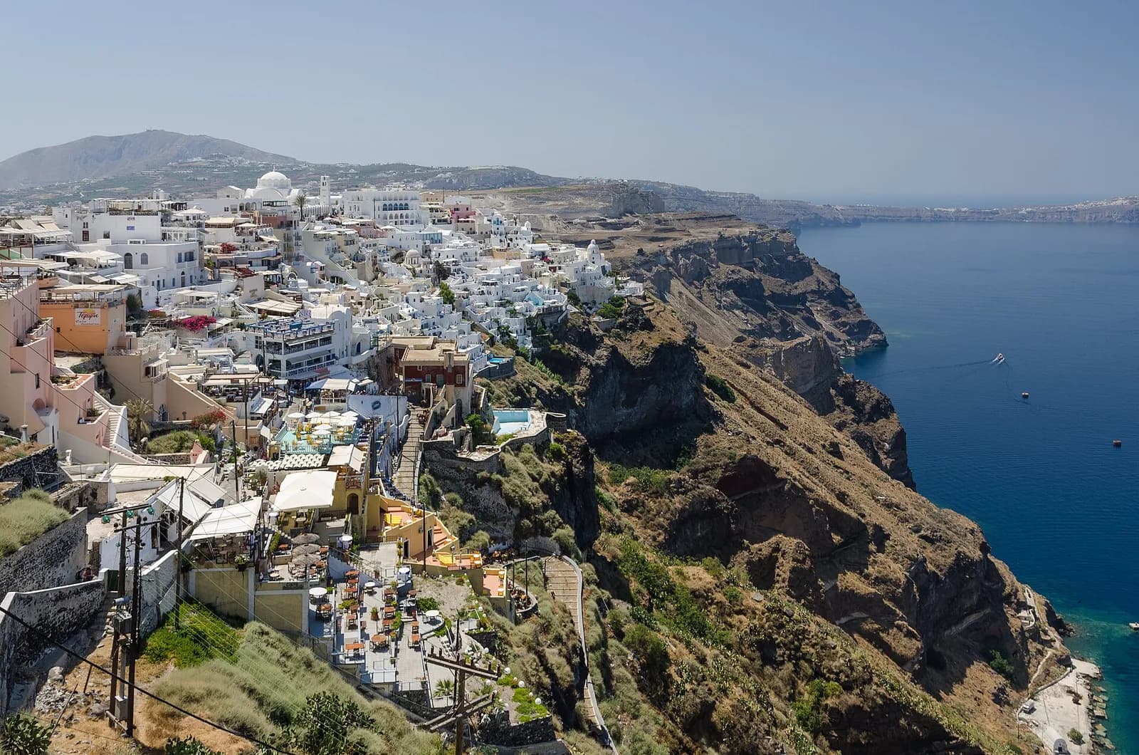the white houses of Fira clinging to the rim of Santorini's caldera