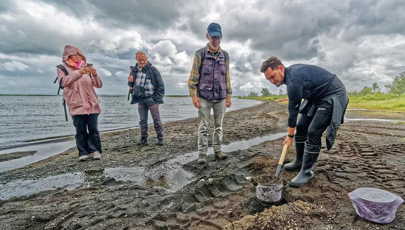 un boulanger creuse le sable géothermique au bord du lac Laugarvatn pour y cuire le pain