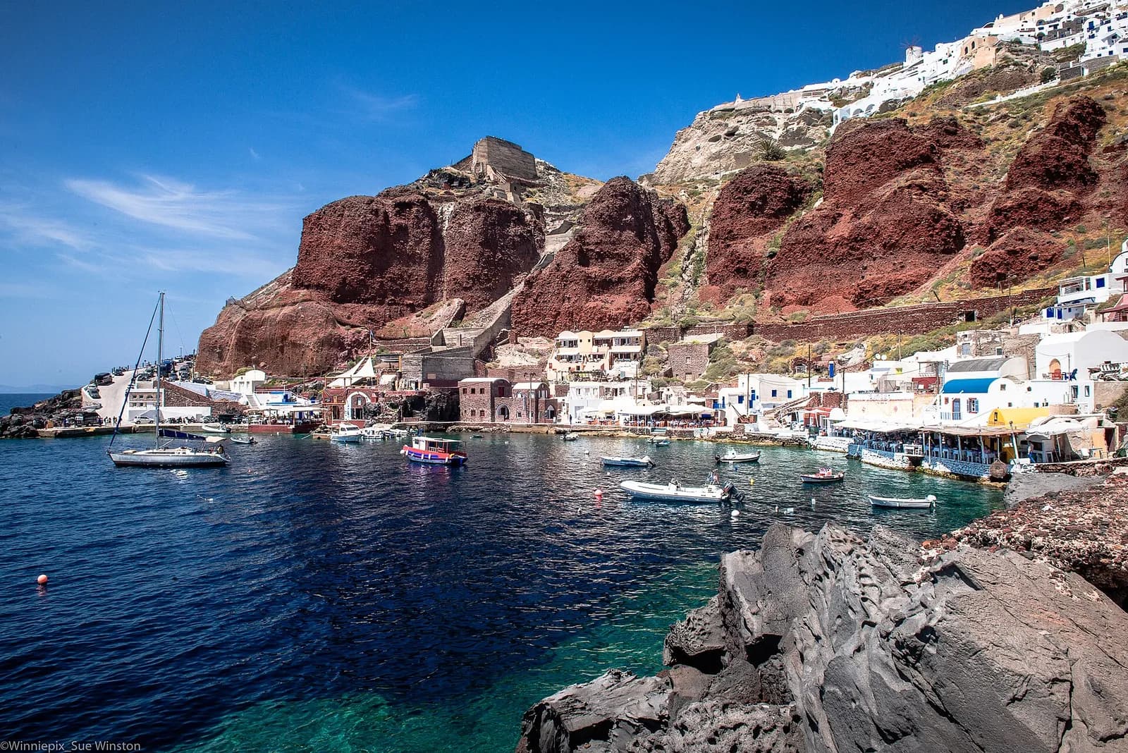 tavernas lined up along the waterfront in Ammoudi Bay, below Oia