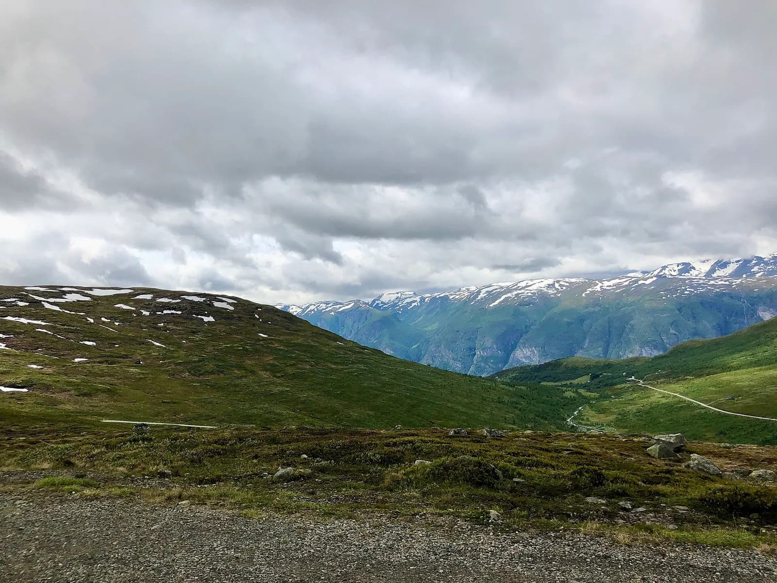 vallée verdoyante et montagnes enneigées vues depuis la route d'Aurlandsfjellet