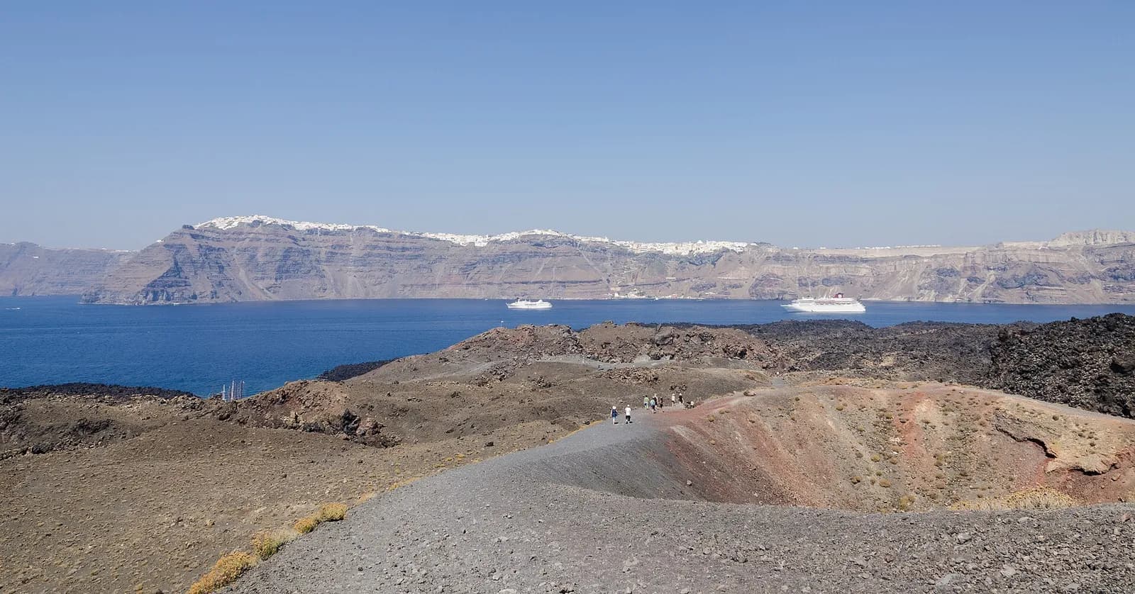 a trail through the Nea Kameni crater facing the Santorini cliffs