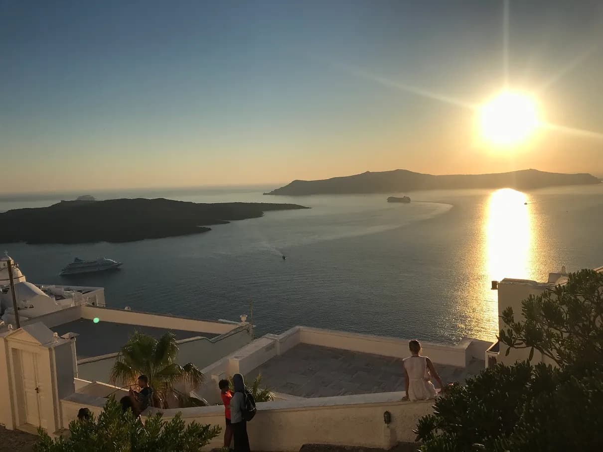 sunset over the Santorini caldera seen from a terrace