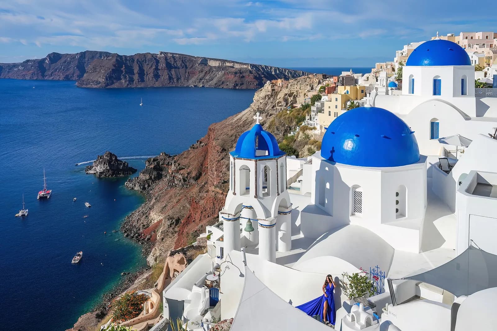 the three blue domes of Oia overlooking the Santorini caldera