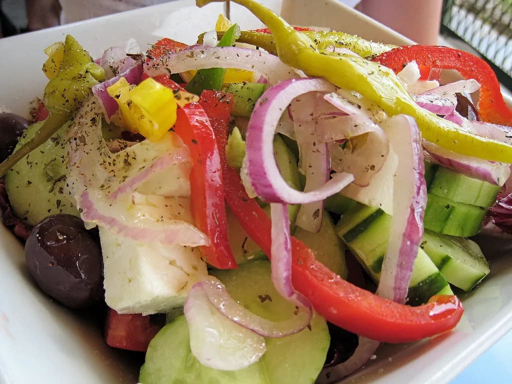 colourful Greek salad with peppers, red onion, olives and feta