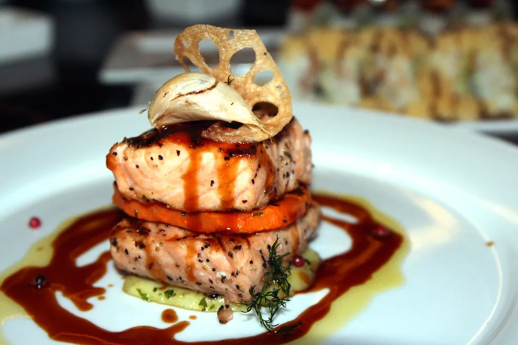 grilled salmon fillet with a reduction sauce, plated fine-dining style