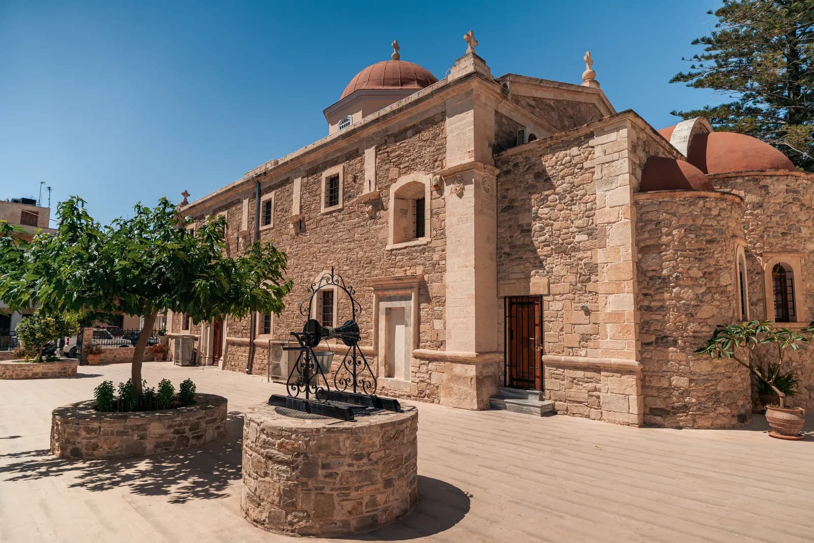 Stone church with red domes on a square in Ierapetra old town