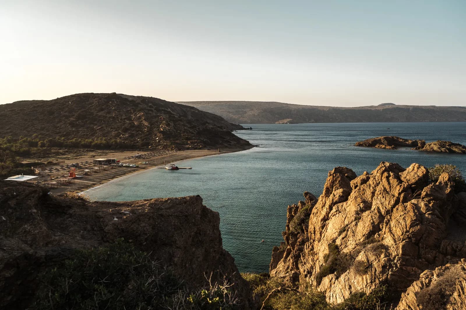 Vai bay at the end of the day, its curved beach and rocks gilded by the evening light