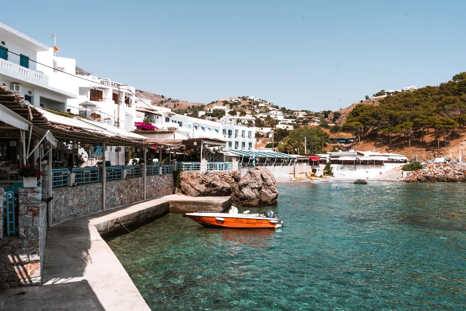 The Loutro waterfront, its white houses and tavernas beside turquoise water, without a single car