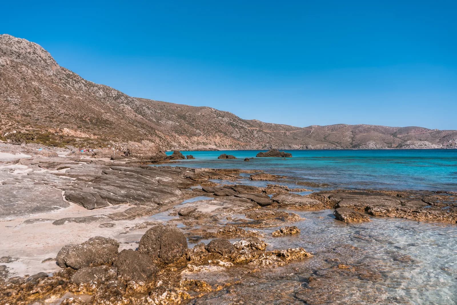 Wild beach of pale sand and rocks in turquoise water, on the south-west coast near Elafonisi
