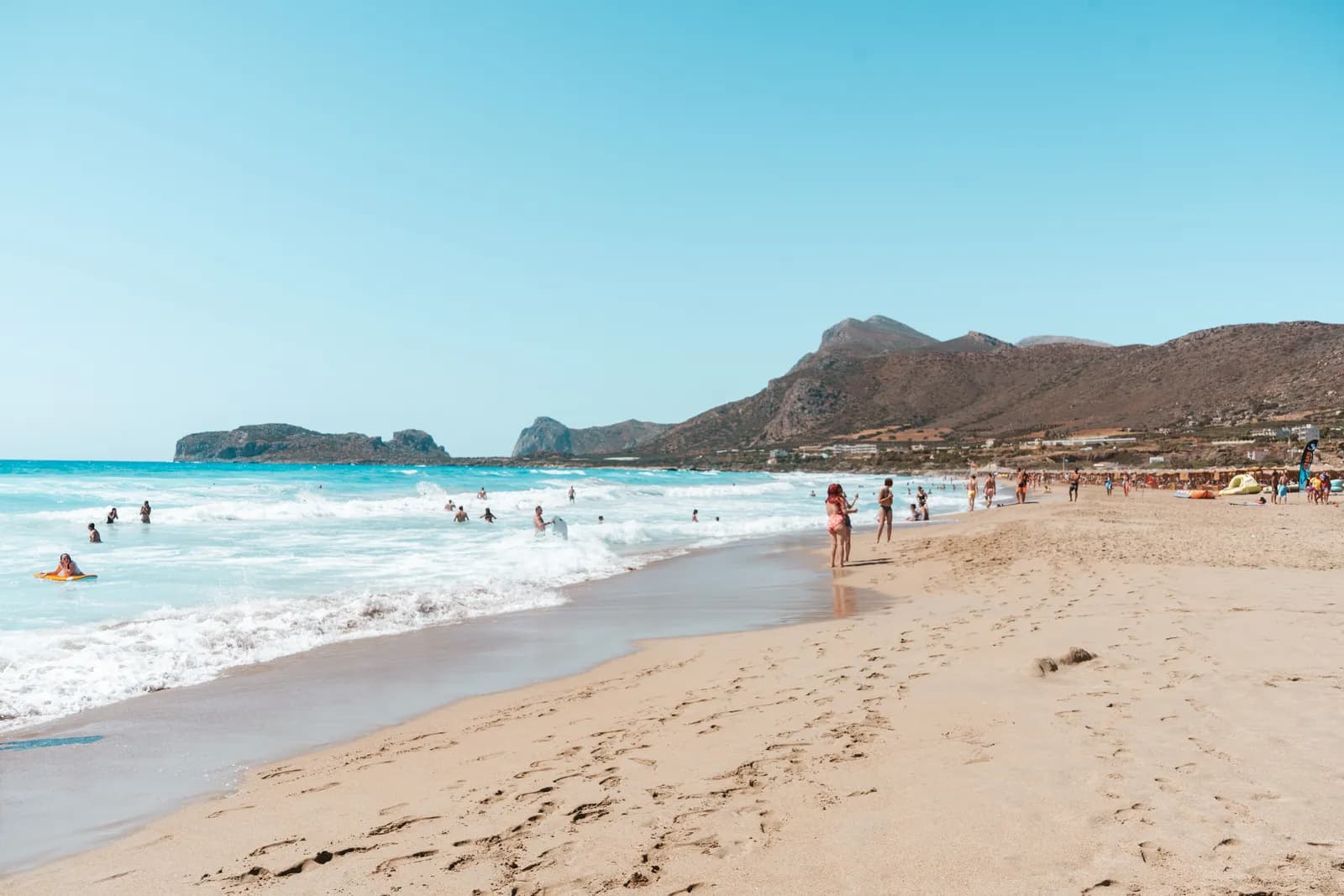 The big beach at Falassarna, its golden sand and waves, closed off to the north by the rocky cape