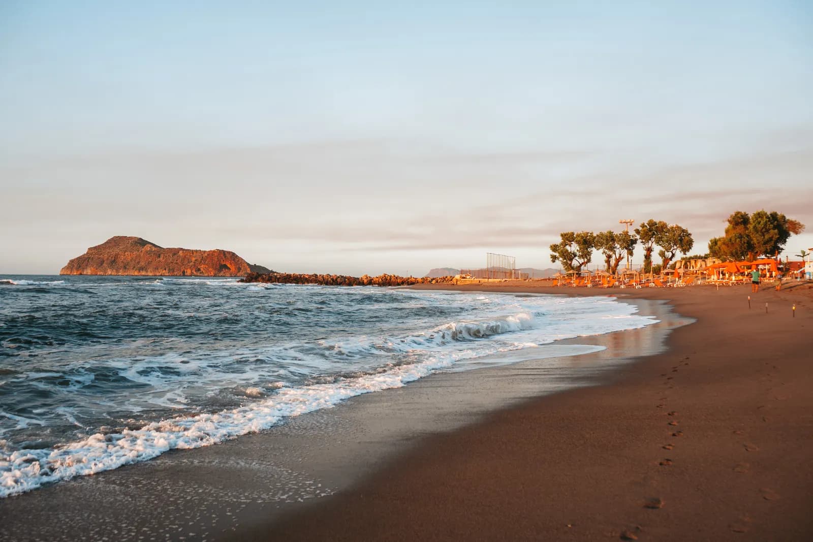 La plage de sable de Platanias à la lumière du soir, face à l'îlot de Theodorou au large d'Agia Marina