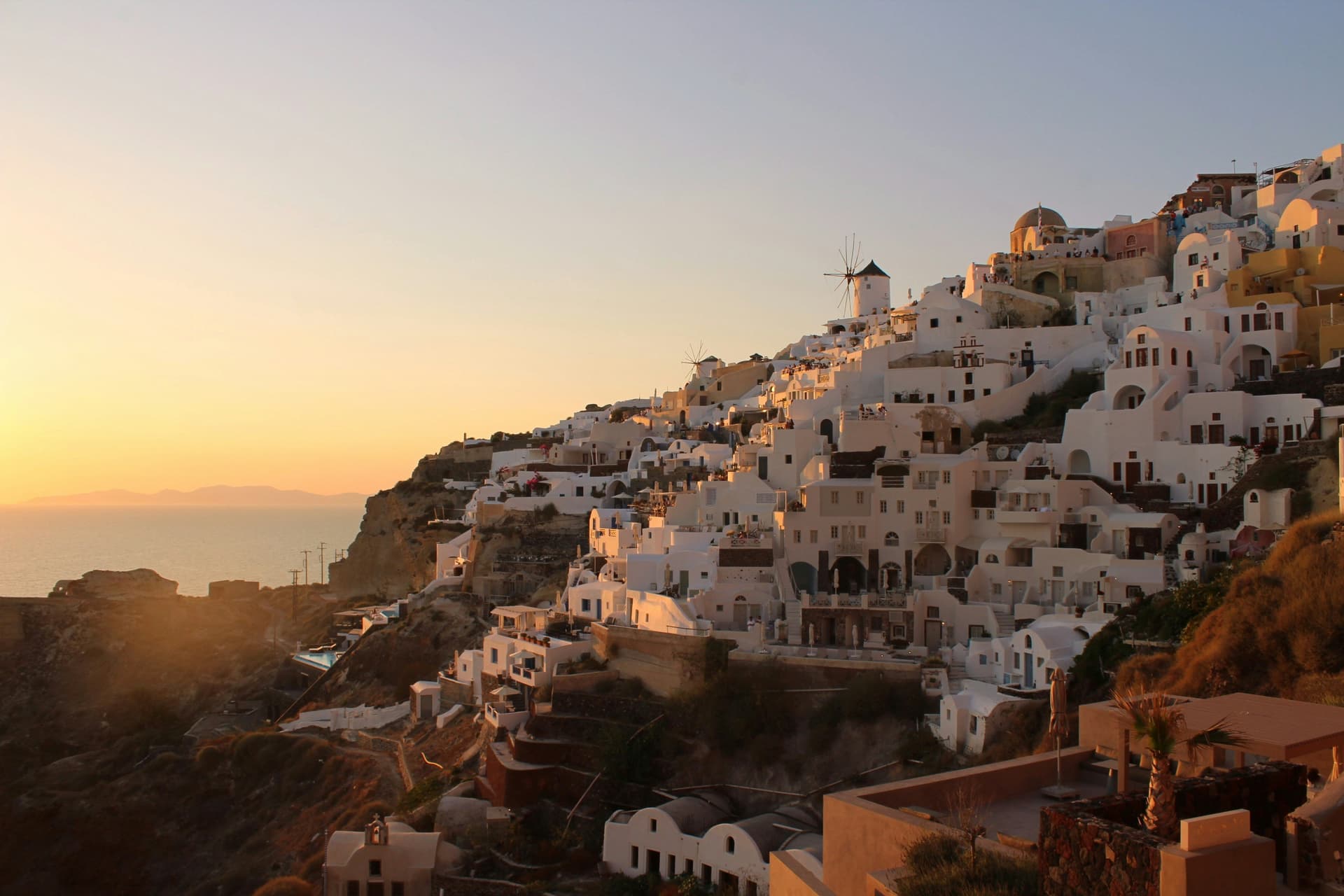 Golden sunset over the village of Oia and the Santorini caldera