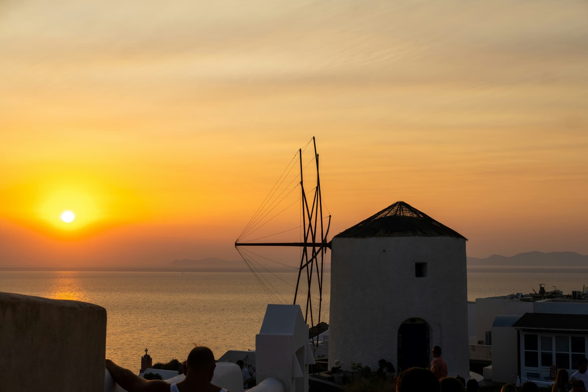 Crowd gathered at Oia Castle to admire the sunset over the caldera