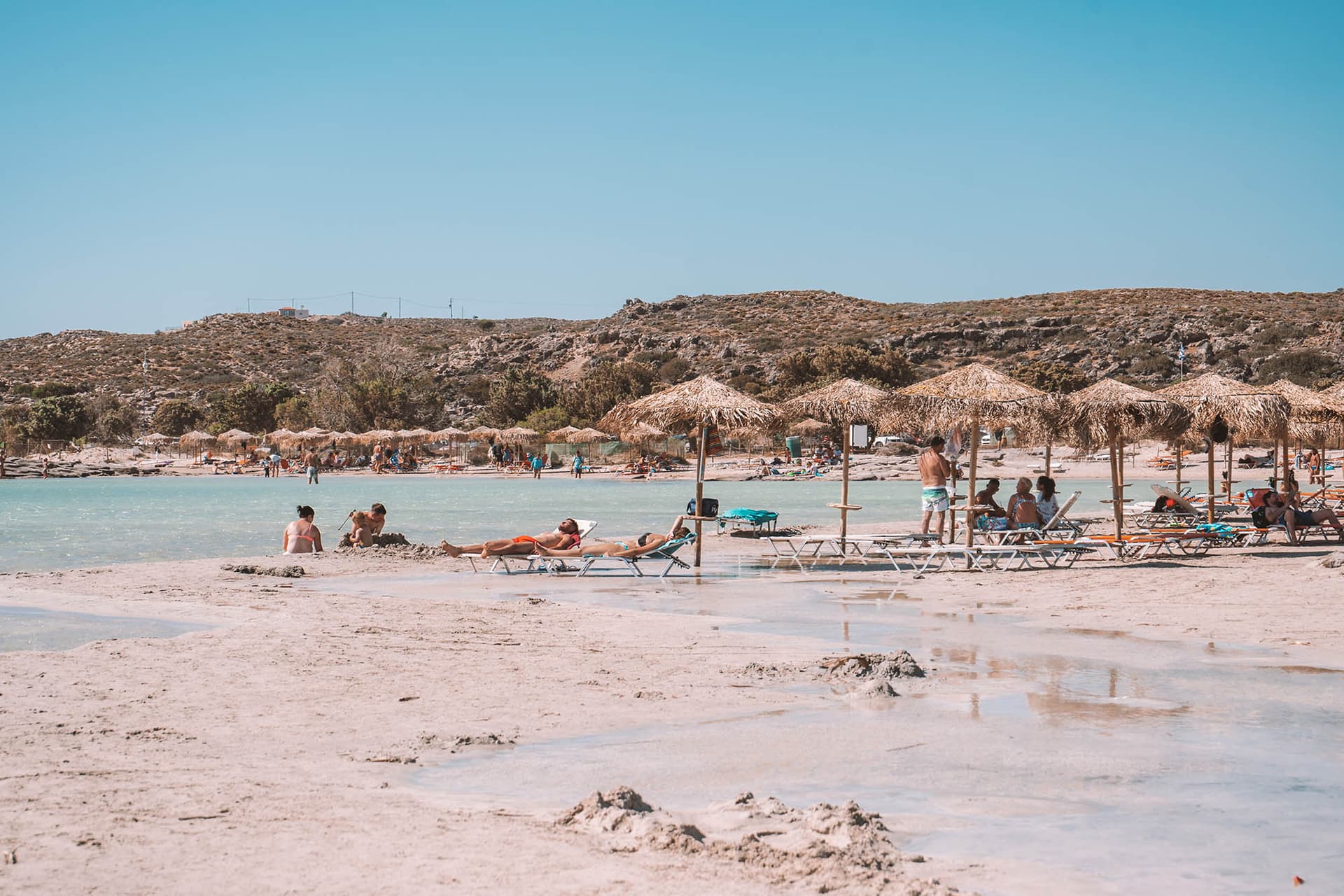 Overview of Elafonisi Beach in high season with sun loungers and visitors