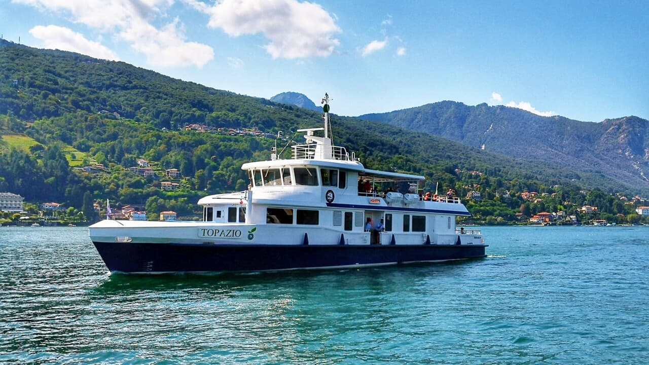 The three types of Lake Como boats: battello, aliscafo and traghetto at Bellagio harbour