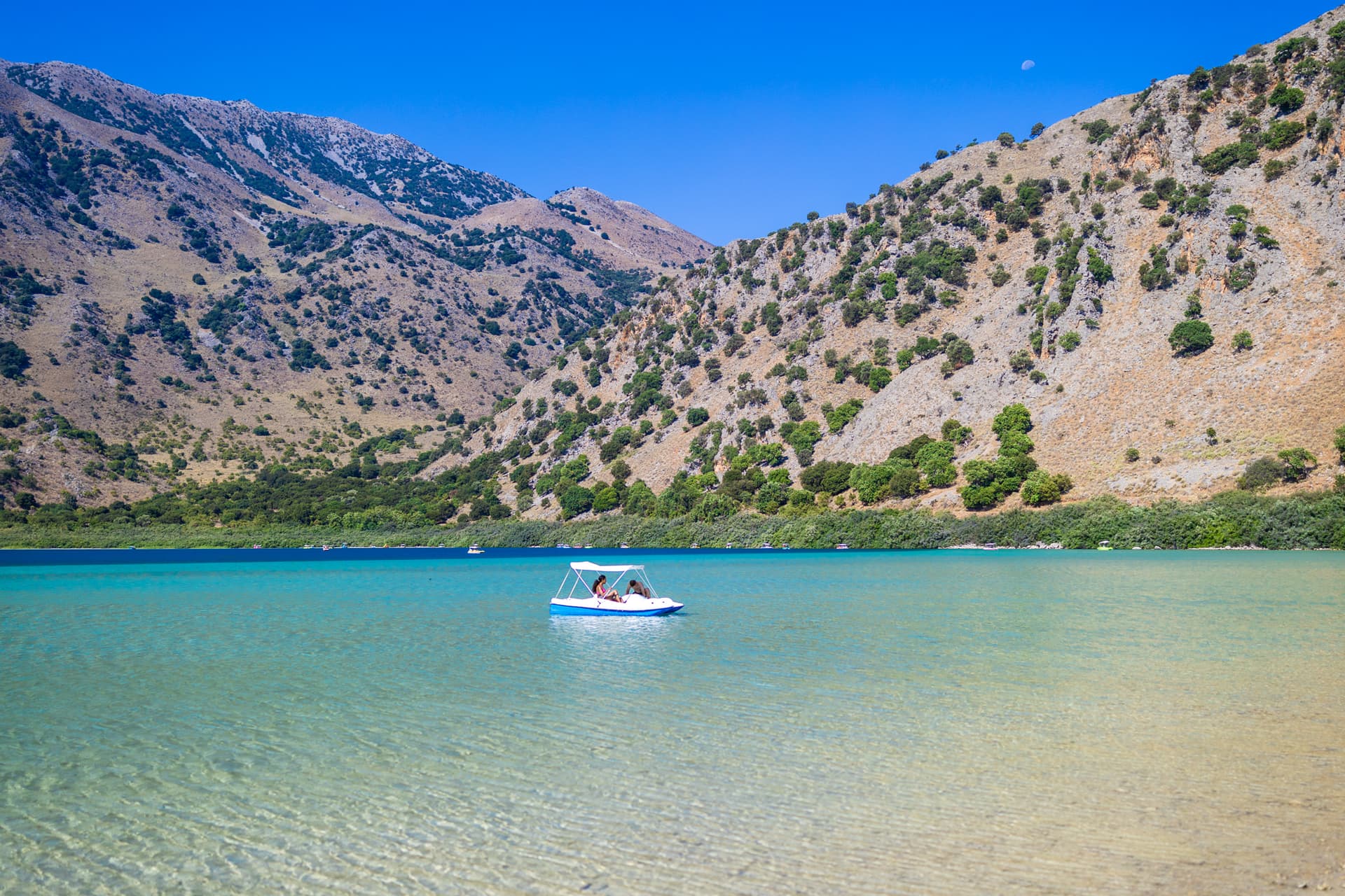 Reflections of the White Mountains in the crystal-clear waters of Lake Kournas