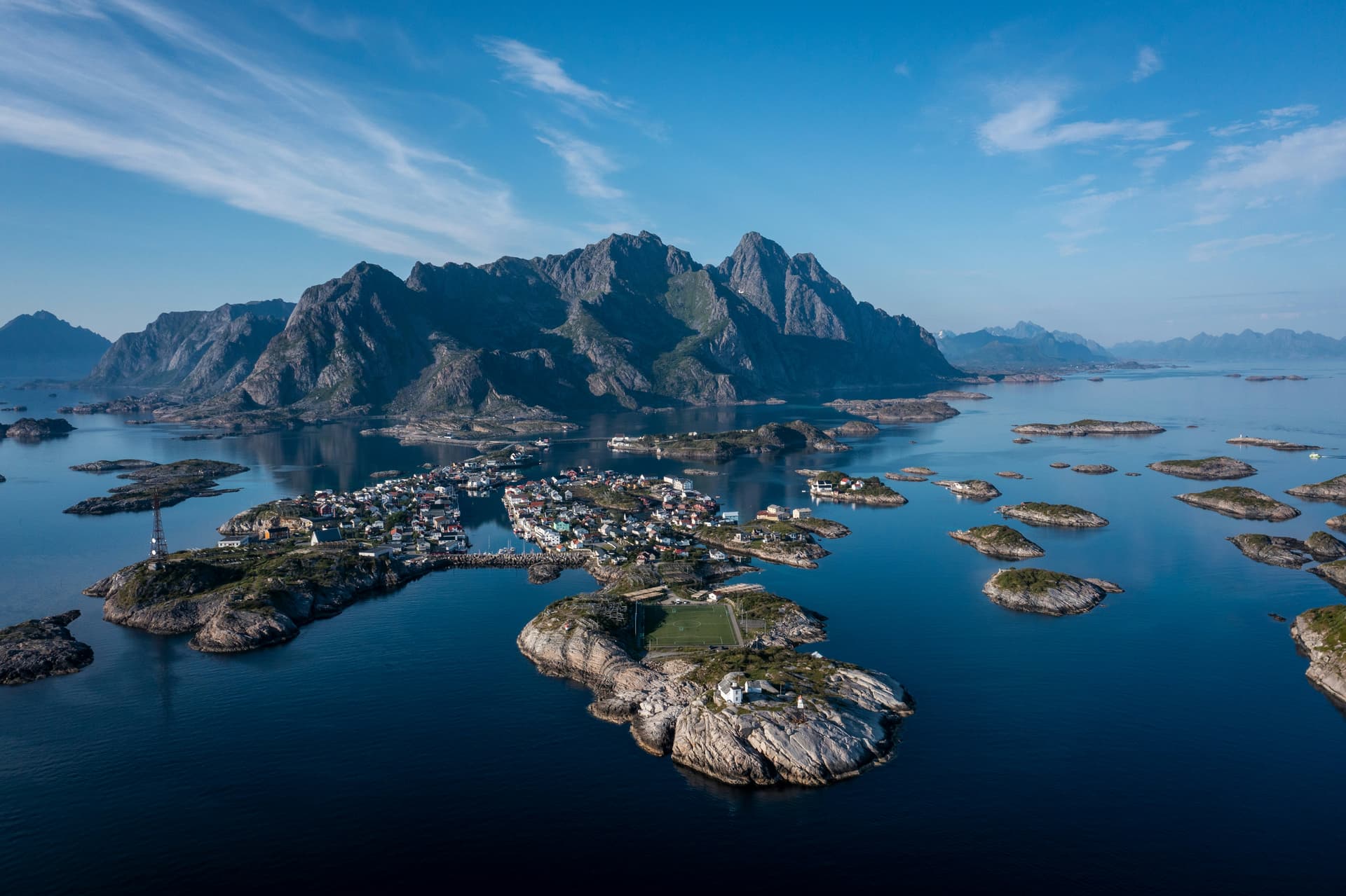 The harbour of the fishing village of Henningsvær in Lofoten with its white wooden houses