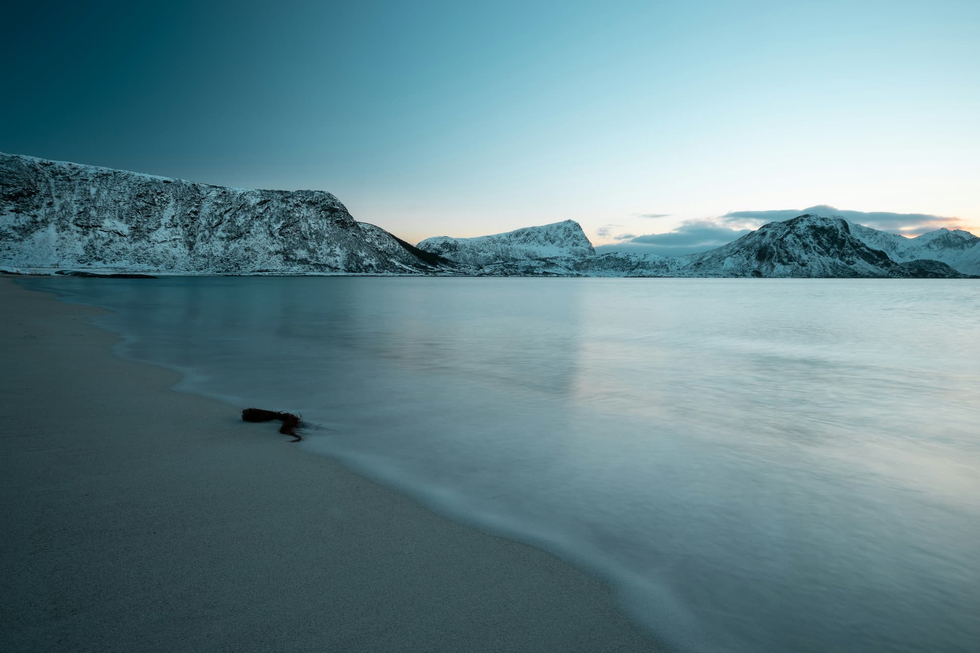 Haukland Beach in Lofoten with its white sand and turquoise water surrounded by mountains