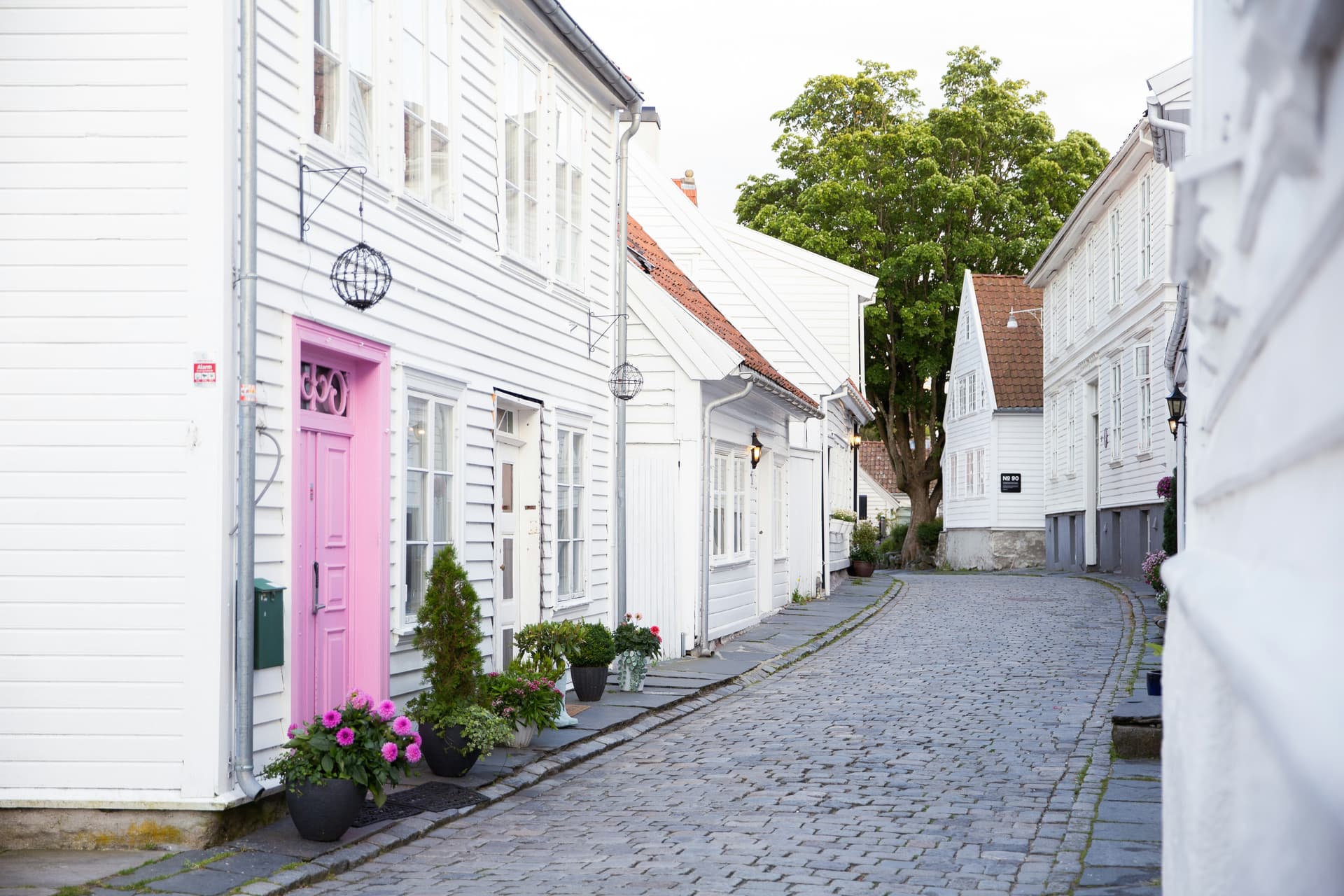 Cobbled lane lined with white wooden houses in old Stavanger