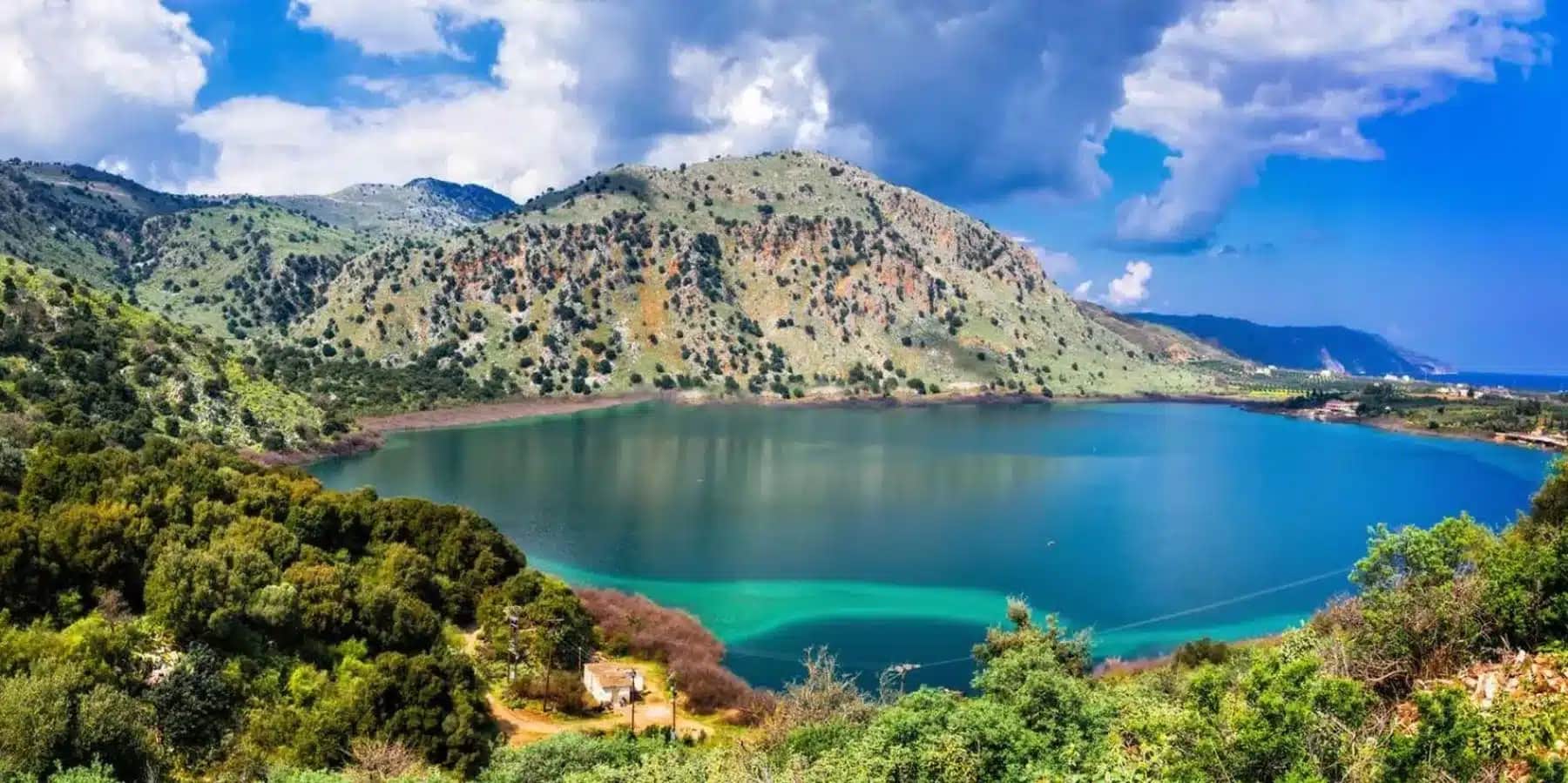 Panoramic view of Lake Kournas surrounded by mountains in Crete