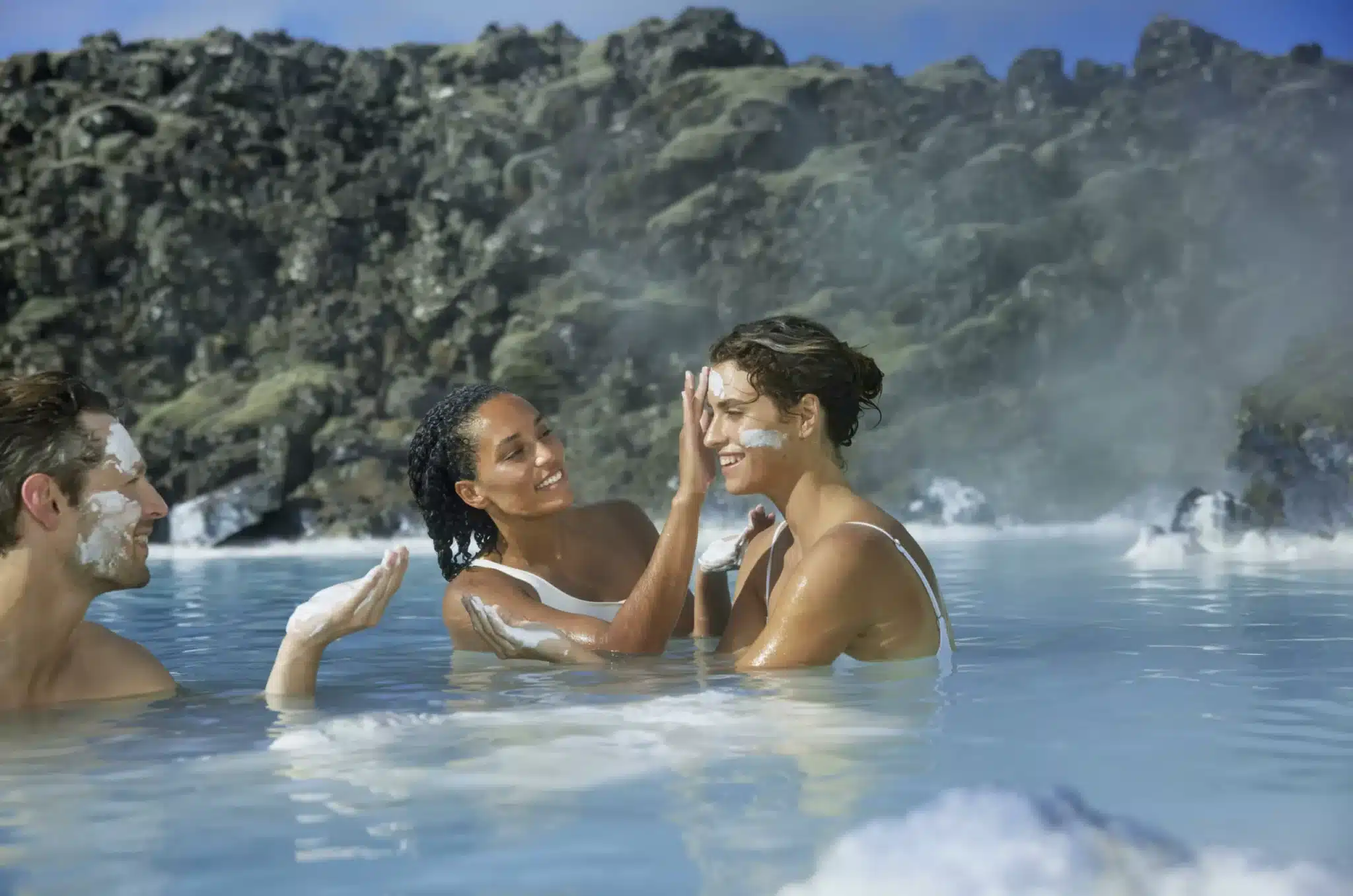 Black lava formations surrounding the turquoise waters of the Blue Lagoon